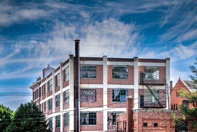 Low angle view of building against cloudy sky