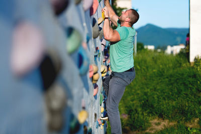 Rear view of man standing by fence