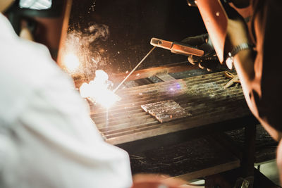 Low angle view of man working on fire