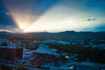 High angle view of illuminated cityscape against sky during sunset