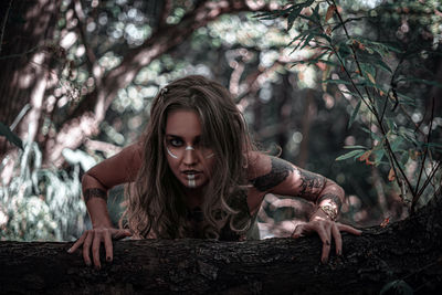 Portrait of woman against plants