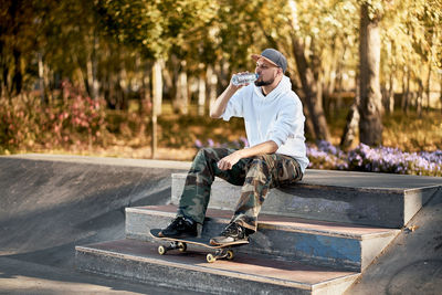 Full length of man with skateboard in city