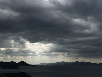 Scenic view of silhouette mountain against dramatic sky