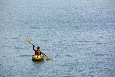 Woman kayaking on sea