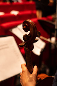 Close-up of human hand holding violin