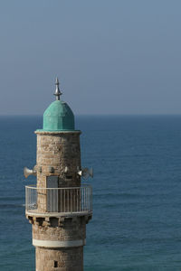 Minaret by sea against clear sky in tel aviv