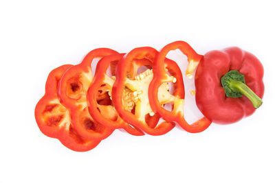 Close-up of red bell peppers against white background