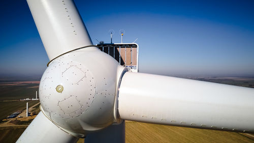 Aerial view of part of windmill turbine in countryside, green energy