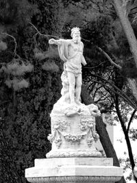 Low angle view of statue against trees