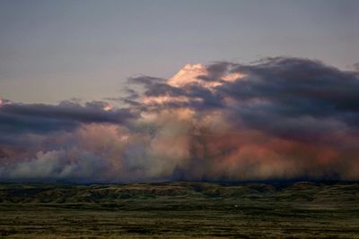 Scenic view of dramatic sky over land