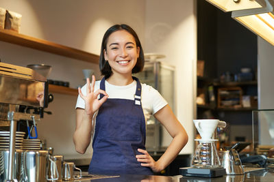 Portrait of young woman sitting at home