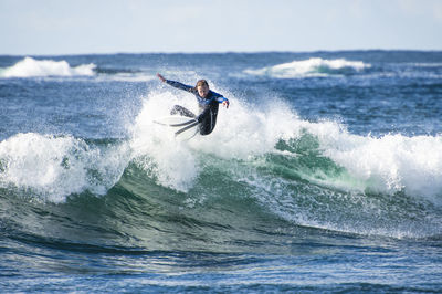 Surfer exploring the coast of ireland on a surf trip