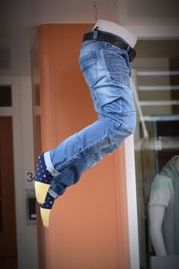 Midsection of man hanging against door at home