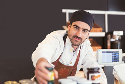Portrait of confident male owner working in grocery store