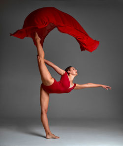 Full length of woman jumping against sky