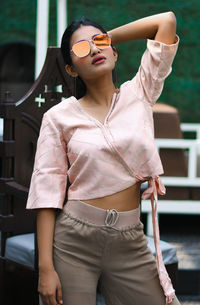 Young woman wearing sunglasses while standing outdoors