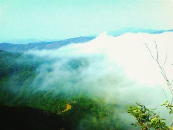 Scenic view of mountains against cloudy sky