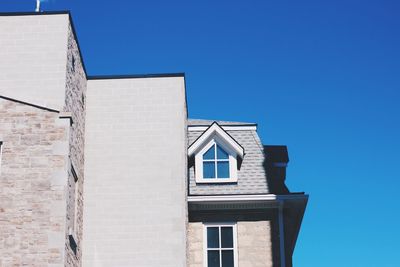 Low angle view of house against clear blue sky