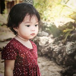 Close-up of cute girl against plants