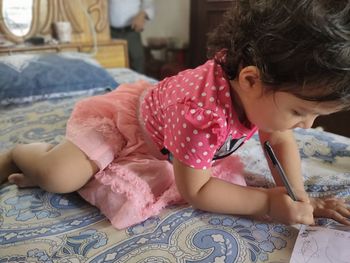 Cute girl lying on bed at home