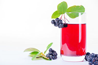 Fruits on glass against white background