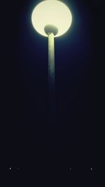 Low angle view of illuminated lamp post at night