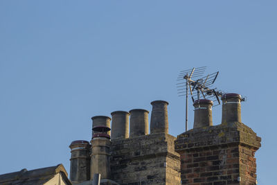 Low angle view of historic building against clear blue sky