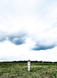 Man standing on field against sky