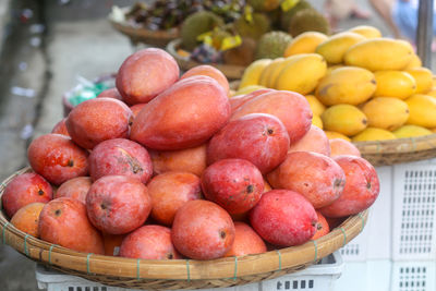 Fruits such as red and yellow mango are sold at dam market, nha trang city , khanh hoa