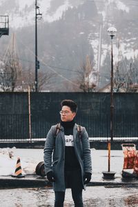 Portrait of young man standing in winter