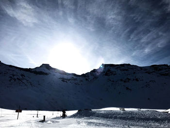 Scenic view of snow covered mountains against sky