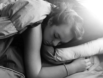 Close-up of baby girl on bed