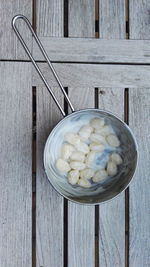 Close-up of gnocchi in a pot on wood