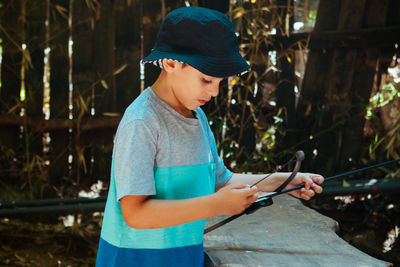 Kid portrait with bow and arrow on forest 