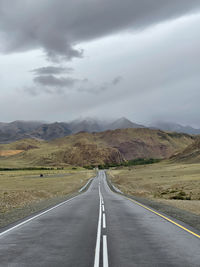 Empty road along countryside landscape