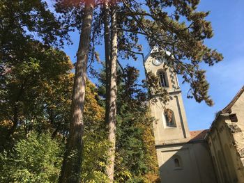 Low angle view of bell tower against sky