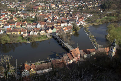 High angle view of buildings by lake