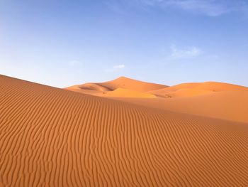 Scenic view of desert against blue sky