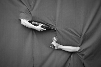 Hand and leg  with bottle and wineglass