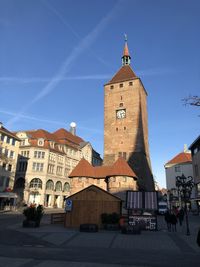 View of city buildings against blue sky