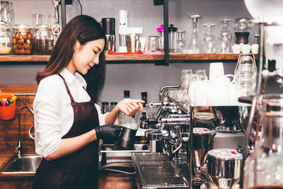 Woman working with coffee in cafe