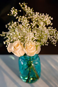 Close-up of rose bouquet in vase on table