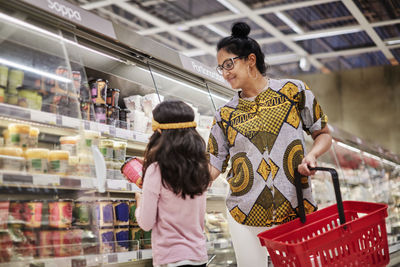 Mother with daughter in supermarket