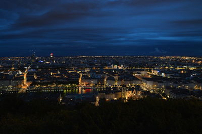 High angle view of city lit up at night