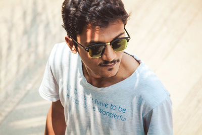 Young man wearing sunglasses looking away outdoors