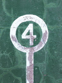 Close-up of arrow sign on road