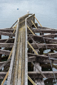 High angle view of weathered dock against the sea