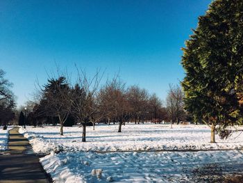 Scenic view of snow covered landscape against clear sky