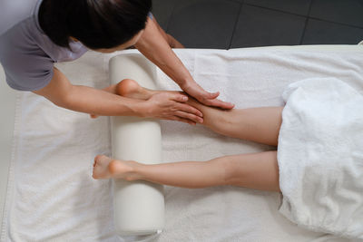 Child foot massage treatment by professional massage therapist in spa resort. wellness stress relief