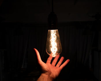 Close-up of hand holding light bulb